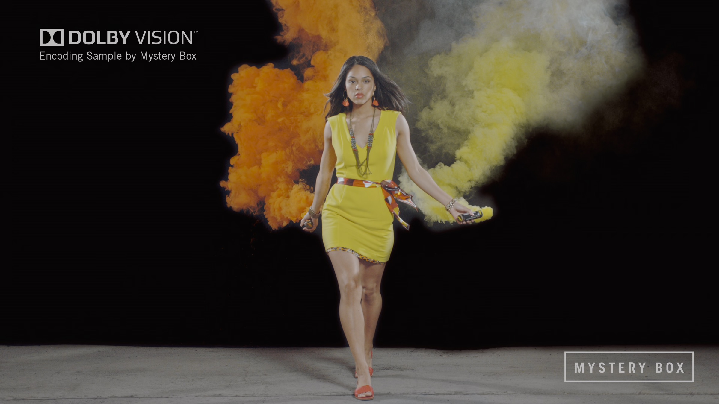 Stoic playing a Dolby Vision frame: orange and yellow smoke, yellow dress, grey floor